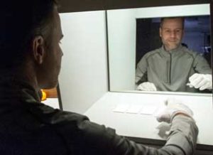 Kevin Houser, prof. of architectural engineering at Penn State, sorts tiles in a light box in the departments illuminating engineering lab for observation under several light sources. Image: Patrick Mansell