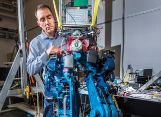 Steve Buerger is leading a Sandia National Laboratories project to demonstrate how energy efficient biped walking robots could become. Increased efficiency could enable bots to operate for much longer periods of time without recharging batteries, an important factor in emergency situations. Photo: Randy Montoya