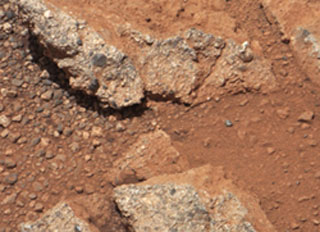 The individual stones in the area are rounded like pebbles on Danish shores and were probably transported down through a ravine, Peace Vallis, which is carved in the southern slope of the northern crater wall. Malin Space Science Systems