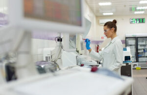 A female scientist controls the operation of devices for laborat
