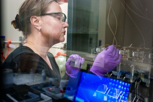 A Sandia researcher carefully handles samples during experiments on metal-organic frameworks (MOFs).