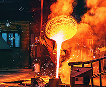 Liquid iron molten metal pouring in container, industrial metallurgical factory, foundry cast, heavy industry background.