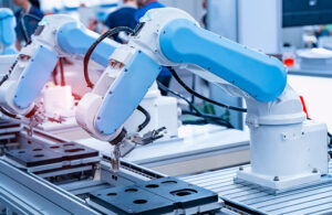 robotic arm catch for electronic assembly line. The robot for smart technology manufacturing process.