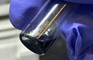 The purple/blue solution in this vial contains crystals of the berkelocene “sandwich.” (Credit: Alyssa Gaiser/Berkeley Lab)
