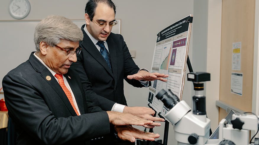 Purdue electrical and computer engineering PhD candidate Sam Peana, right, discusses his research focused on nanostructured single photon emitters with Sethuraman Panchanathan, director of the National Science Foundation, during his recent campus visit, which included a stop at Birck Nanotechnology Center. (Purdue University photo/Kelsey Ann Lefever)