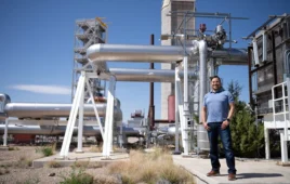 Sandia National Laboratories’ Kenneth Armijo, project lead, stands beside the Sandia Molten Salt Test Loop, the world’s largest lab-scale molten salt testing facility. (Photo by David Lienemann)
