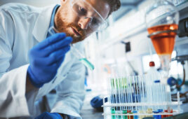 Male attractive student of chemistry working in laboratory