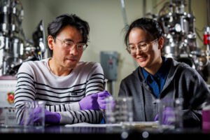 Jeehwan Kim (left) and Xinyuan Zhang working on ultrathin electronic membranes.<br />Photo: Adam Glanzman