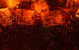 Detail of cola drink with ice cubes, fresh beverages background.