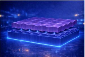 Conceptual illustration of the nanofaceted substrate (bottom, blue) and ultrathin YBCO superconducting film (top, purple). The sculpted ridges in the MgO substrate — roughly 1 nm tall — guide atomic arrangement and electron behavior at the interface, inducing a directional electronic state that enhances superconductivity. (Credit: Chalmers University of Technology / Riccardo Arpaia)
