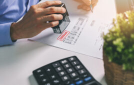 businessman accepting and stamping procurement bill in office