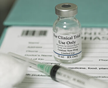 Clinical trial medicine, for the covid-19 coronavirus, on clipboard