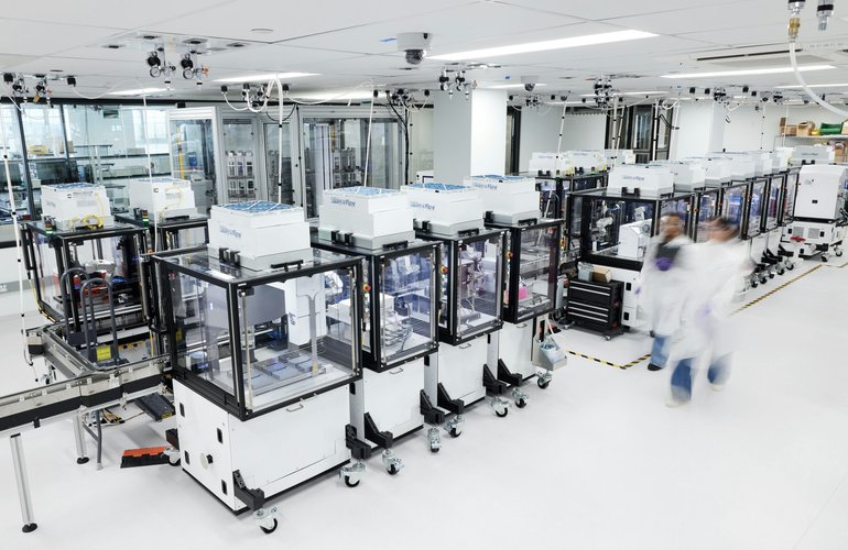 Ginkgo's Reconfigurable Automation Carts lined up in the foundry. The wheeled, modular units are designed to be rolled into different workflow configurations rather than bolted into a fixed line. [Photo: Ginkgo Bioworks]