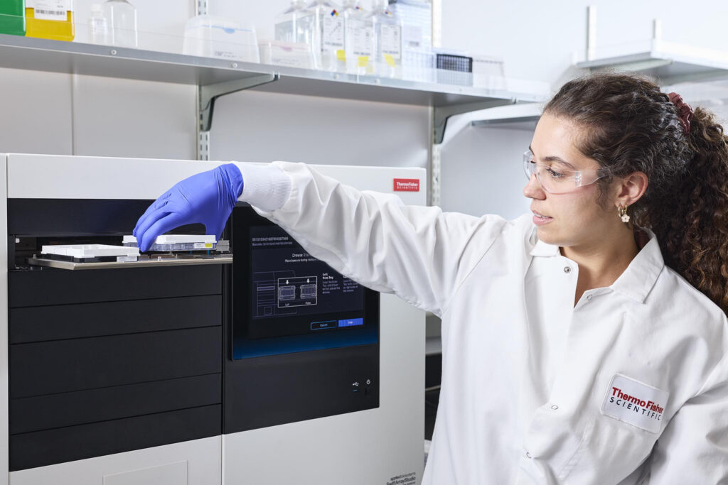 A technician loads samples into the SwiftArrayStudio microarray analyzer. (Image credit: Thermo Fisher Scientific)