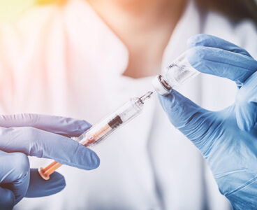 injecting injection vaccine vaccination medicine flu man doctor insulin health drug influenza concept - stock image