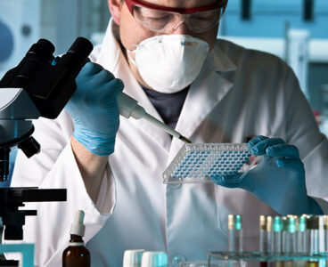 scientist working with microplate in a pharmaceutical lab / biomedical engineer working with samples in microplate in the laboratory