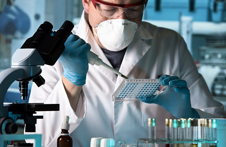 scientist working with microplate in a pharmaceutical lab / biomedical engineer working with samples in microplate in the laboratory