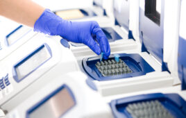 Scientist with DNA copying, Real-time PCR cycler, wide