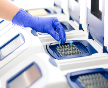 Scientist with DNA copying, Real-time PCR cycler, wide