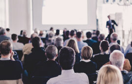 Speaker Giving a Talk at Business Meeting. Audience in the conference hall. Business and Entrepreneurship. Panoramic composition suitable for banners.