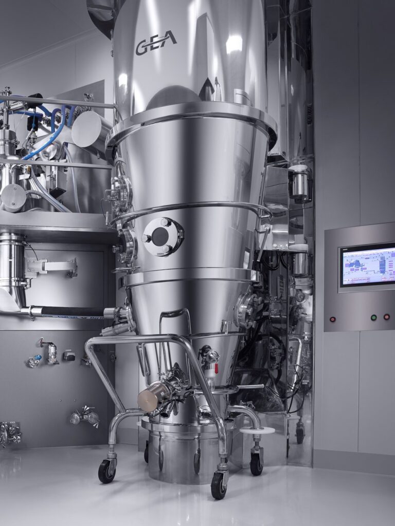 A commercial-scale spray dryer. At this size, factors such as airflow dynamics, heat transfer, and slurry homogeneity introduce challenges not seen at the lab scale, including wall sticking, agglomeration, and particle size distribution shifts. (Genesis AEC)