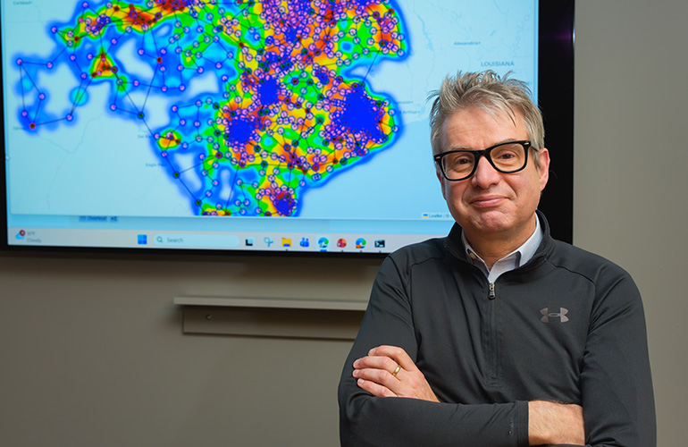 Hendrik Hamann, Brookhaven National Laboratory’s chief AI scientist for Innovation, Science, and Security, demonstrates GridSearch. The software is designed to accelerate the connection of AI data centers, power-generation facilities, and advanced manufacturing plants to the electric grid. Credit: Brookhaven National Laboratory/Tim Kuhn