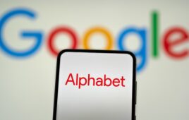 Alphabet logo on a smartphone in front of the Google logo