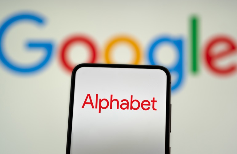 Alphabet logo on a smartphone in front of the Google logo